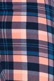 Close-up of colorful plaid fabric pattern featuring navy blue, peach, and light blue squares and stripes, showcasing the texture and vibrant colors of the yoga legging material.