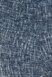 Close-up texture of blue denim fabric with white crosshatch pattern, showcasing the knit material of 5-inch long yoga-style leggings with high waist and multi-print design