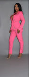 Vibrant pink powersuit with rhinestone-adorned blazer and matching pants, showcasing glamorous style and confident silhouette on gray background