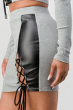 Grey mini skirt with black faux leather panel and lace-up side detail, part of a two-piece set with matching cropped top