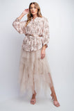 Elegant woman wearing blush floral 3/4 sleeve crepe button-down top with bishop sleeves, paired with flowing tulle skirt, showcasing smock style and relaxed fit for a romantic bohemian look